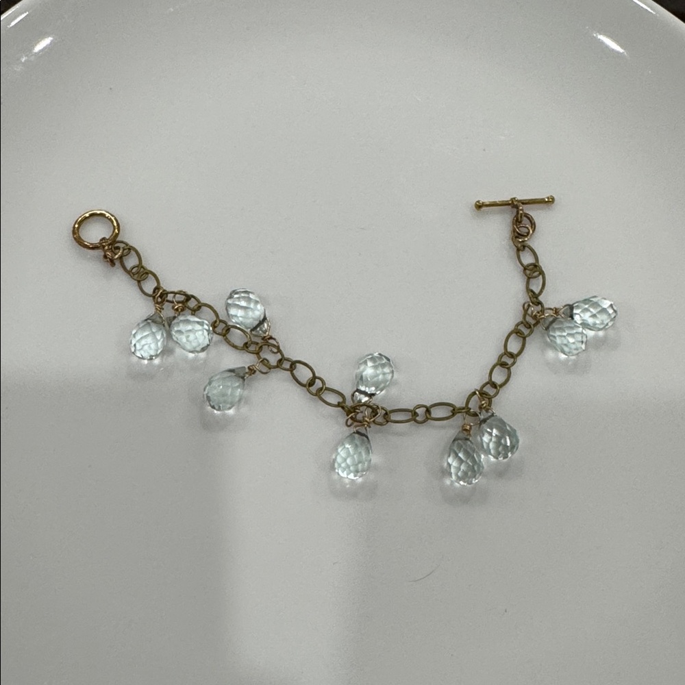 Dangling blue glass and gold chain bracelet